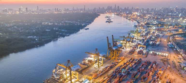 aerial view of an industrial port on a riverfront at dusk